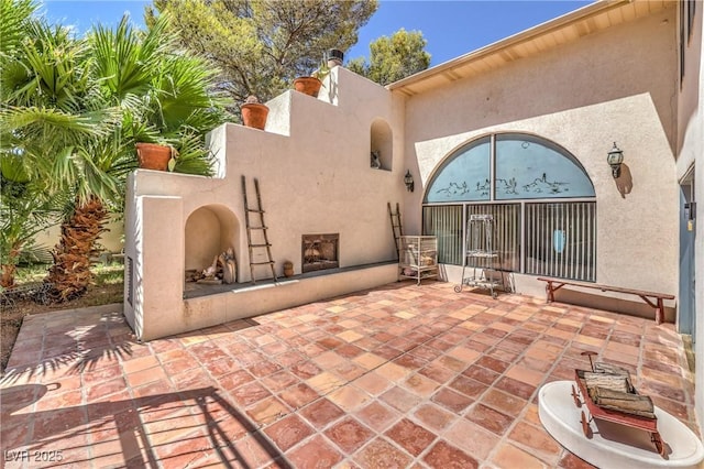 view of patio / terrace featuring an outdoor fireplace