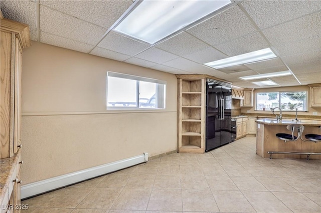 kitchen featuring kitchen peninsula, a paneled ceiling, baseboard heating, built in fridge, and light brown cabinets