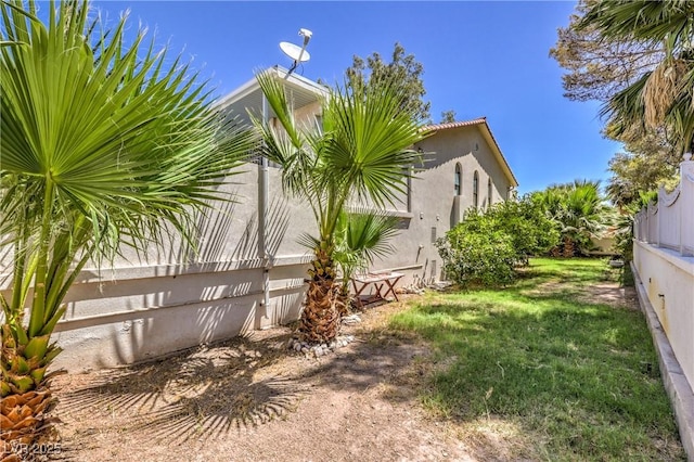 view of side of home featuring a lawn