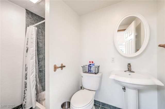 bathroom featuring toilet, walk in shower, and tile patterned floors