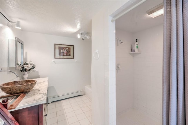 bathroom featuring a textured ceiling, tile patterned flooring, vanity, baseboard heating, and plus walk in shower