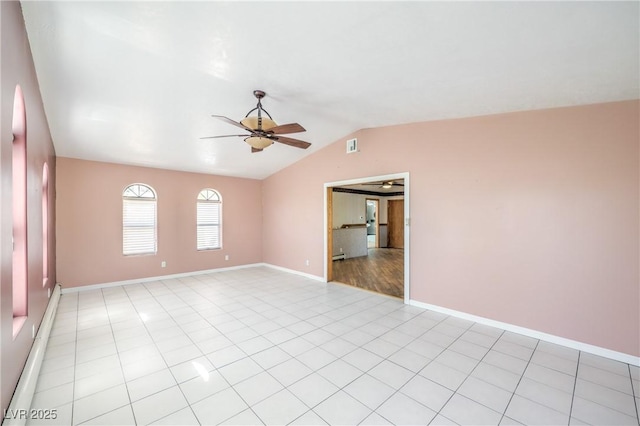 spare room featuring lofted ceiling, ceiling fan, and light tile patterned floors