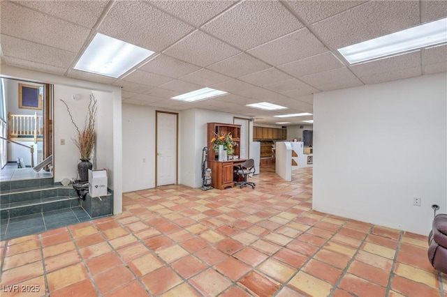 basement featuring a drop ceiling