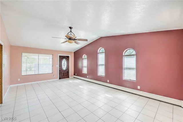 interior space featuring ceiling fan, vaulted ceiling, and a baseboard heating unit