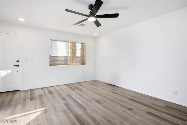 empty room featuring ceiling fan and light wood-type flooring