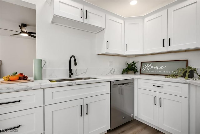 kitchen featuring white cabinets, stainless steel dishwasher, hardwood / wood-style flooring, and sink