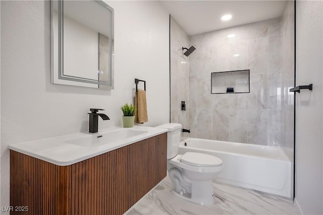 full bathroom with toilet, vanity, and tiled shower / bath