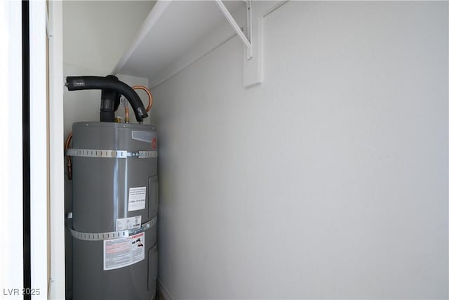 utility room with strapped water heater