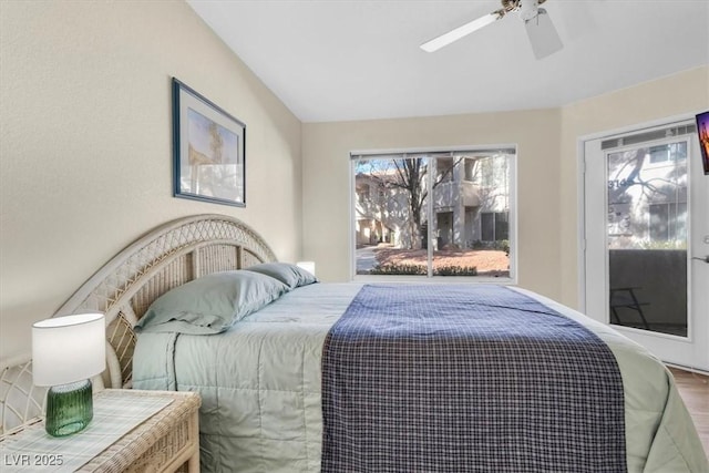 bedroom with vaulted ceiling, ceiling fan, and wood-type flooring