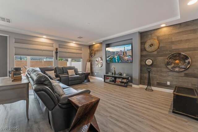 living room with wood walls and hardwood / wood-style flooring