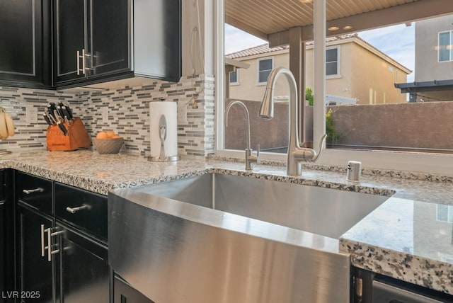 kitchen featuring sink, wooden ceiling, light stone countertops, and decorative backsplash