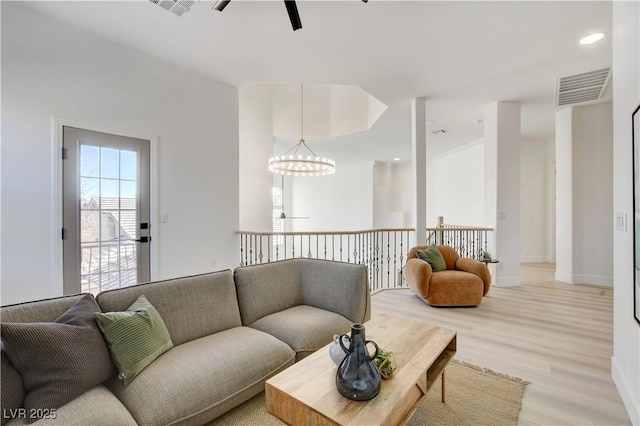 living room featuring light hardwood / wood-style flooring and a chandelier