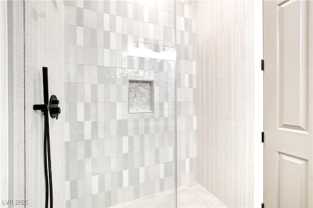 bathroom with tiled shower