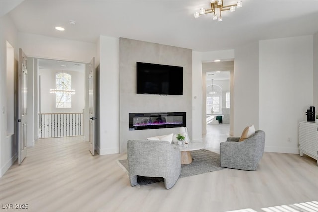 living room with light hardwood / wood-style floors and a fireplace