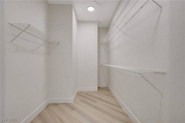 walk in closet featuring hardwood / wood-style floors