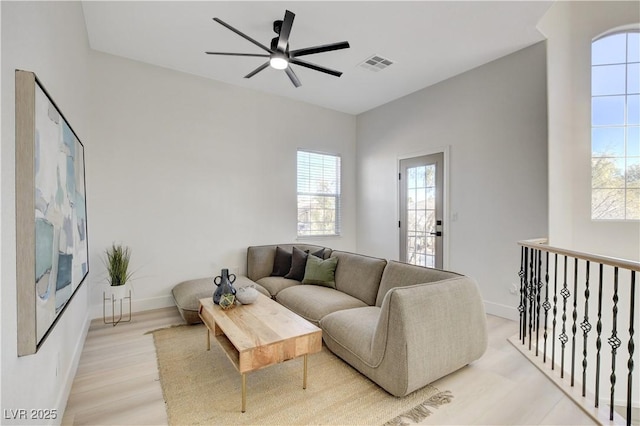 living room featuring ceiling fan and light hardwood / wood-style floors