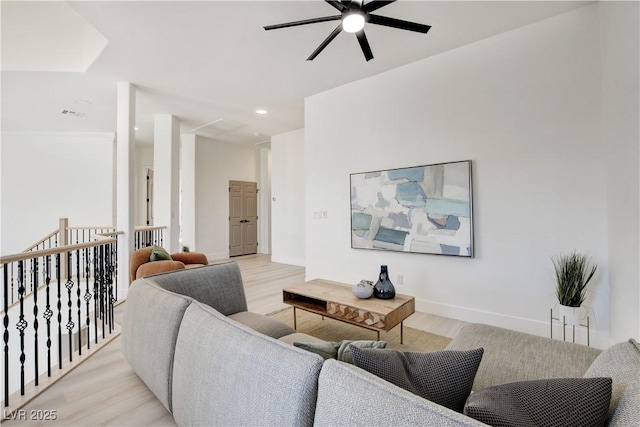 living room featuring ceiling fan and light hardwood / wood-style floors