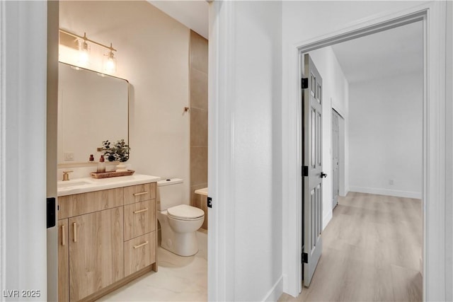 bathroom featuring hardwood / wood-style floors, vanity, and toilet