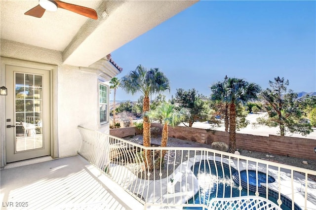 balcony featuring an in ground hot tub