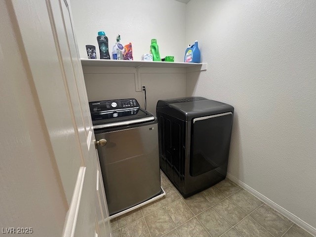 washroom with washing machine and clothes dryer