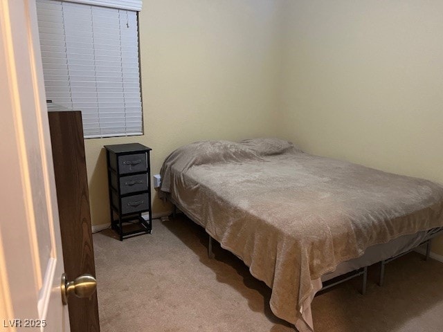 bedroom featuring light carpet