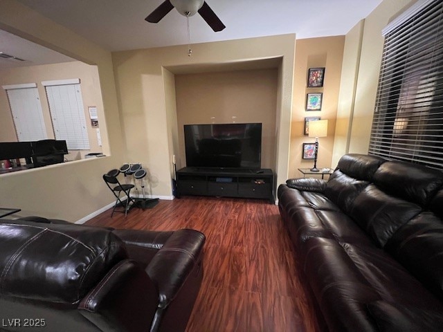 living room with dark hardwood / wood-style flooring and ceiling fan