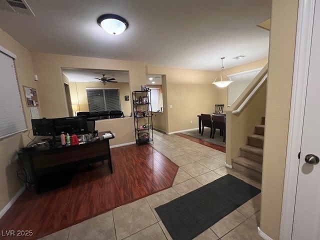 living room with light tile patterned flooring and ceiling fan