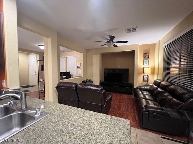 living room with sink, ceiling fan, and hardwood / wood-style flooring