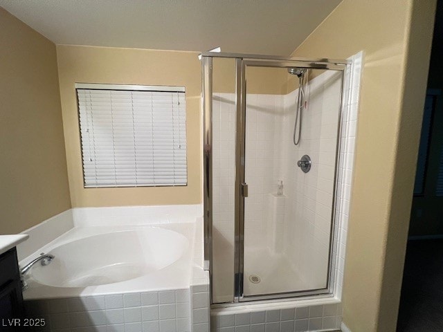 bathroom featuring shower with separate bathtub and vanity