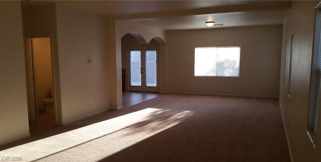 carpeted spare room with french doors