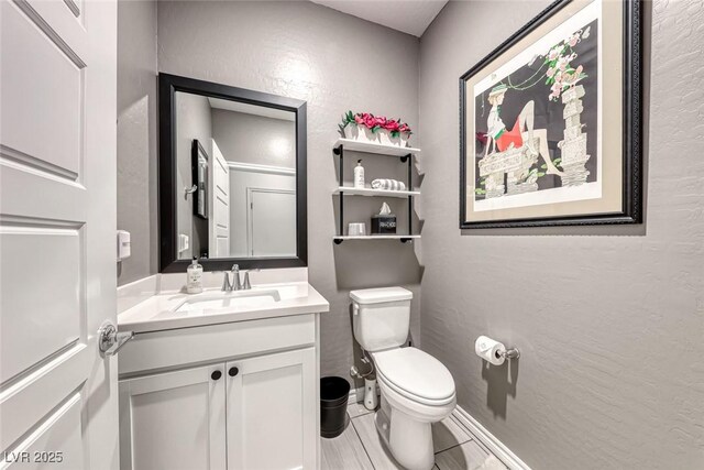 bathroom featuring toilet and vanity