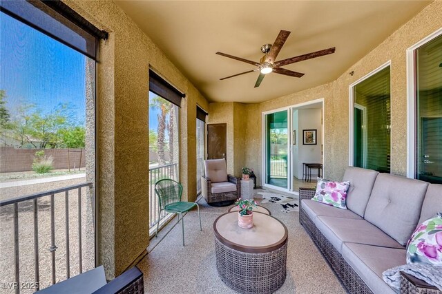 sunroom featuring ceiling fan