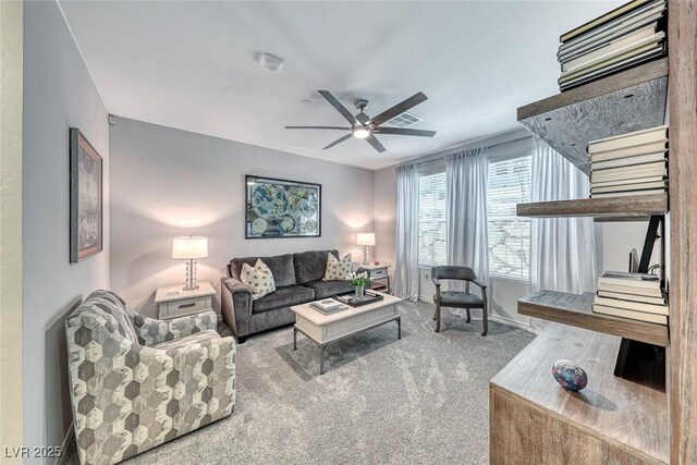 carpeted living room with ceiling fan