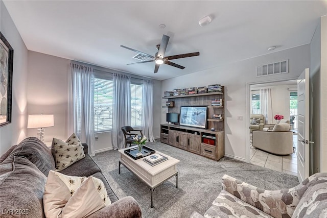 living room featuring ceiling fan and light colored carpet