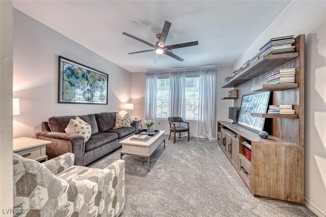 living room featuring ceiling fan and carpet