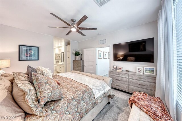 bedroom with ensuite bath, ceiling fan, and carpet