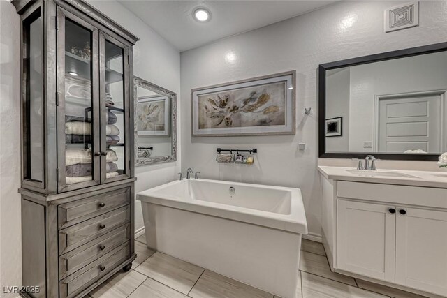 bathroom with a bath and vanity