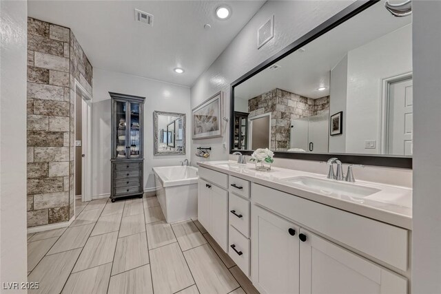 bathroom featuring vanity and shower with separate bathtub