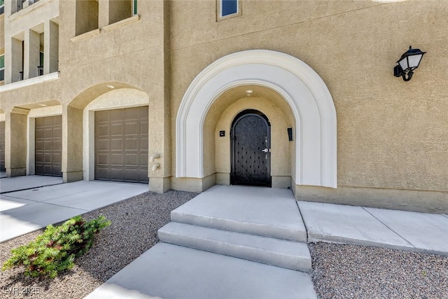 view of exterior entry with a garage