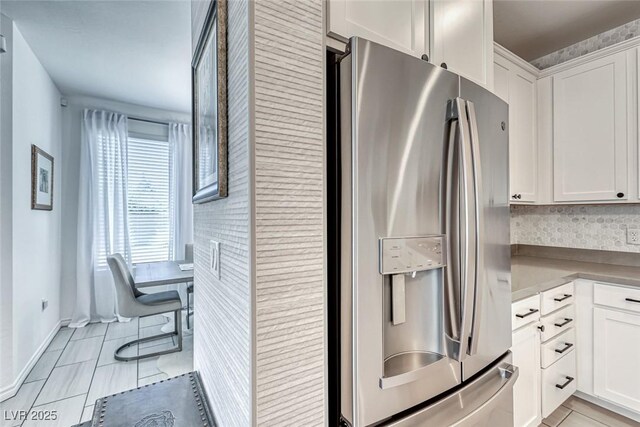 kitchen featuring appliances with stainless steel finishes, pendant lighting, an island with sink, and white cabinetry