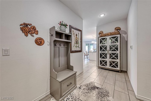 mudroom featuring a notable chandelier