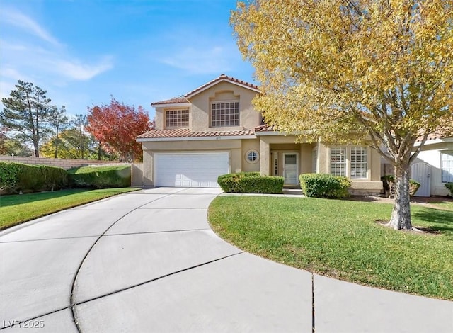 mediterranean / spanish-style house featuring a garage and a front lawn