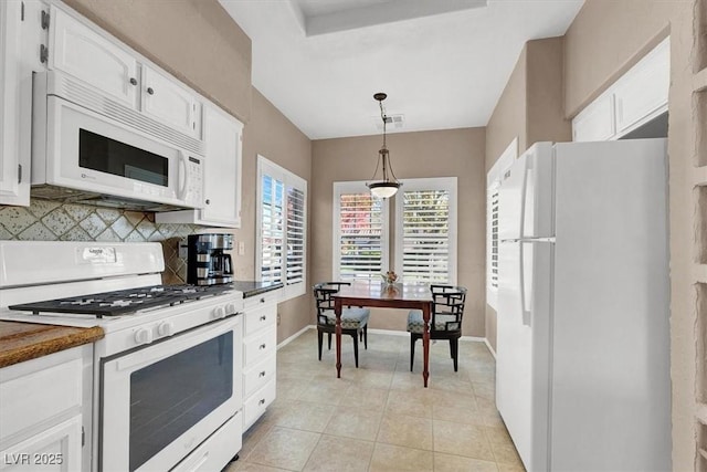 kitchen featuring white cabinetry, white appliances, light tile patterned floors, backsplash, and hanging light fixtures