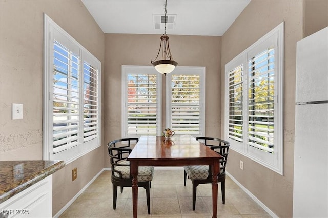 tiled dining space with a wealth of natural light