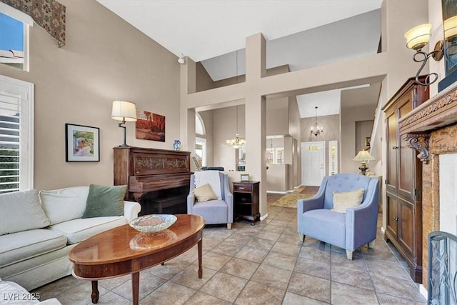 living room with an inviting chandelier, a towering ceiling, and plenty of natural light