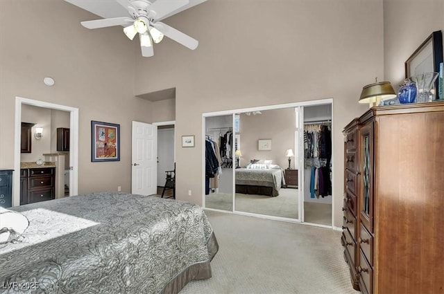 carpeted bedroom featuring a high ceiling and ceiling fan