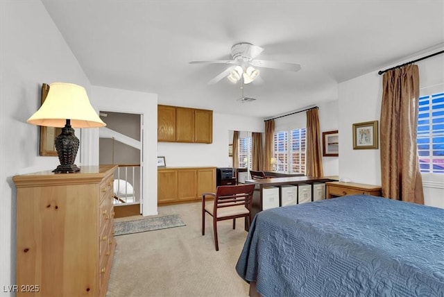 bedroom with ceiling fan and light colored carpet