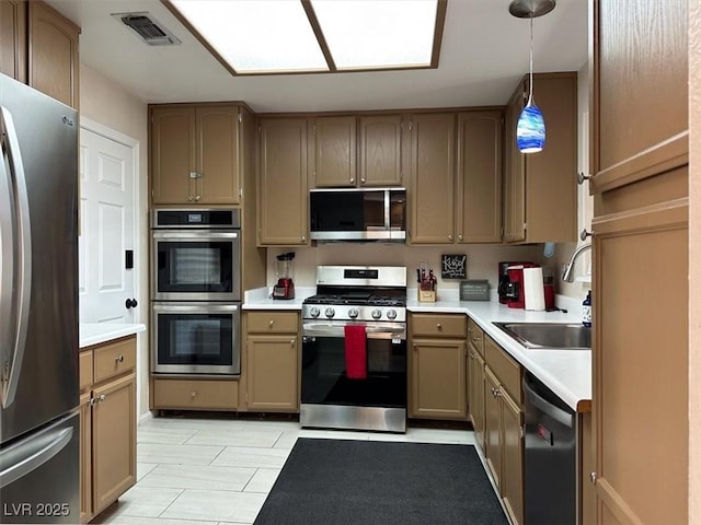 kitchen with stainless steel appliances, hanging light fixtures, and sink