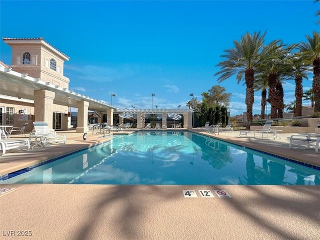 view of swimming pool with a patio area and a pergola