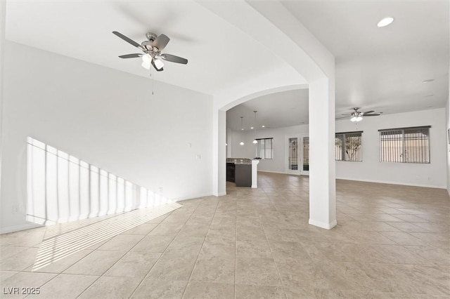 unfurnished living room featuring ceiling fan and light tile patterned floors